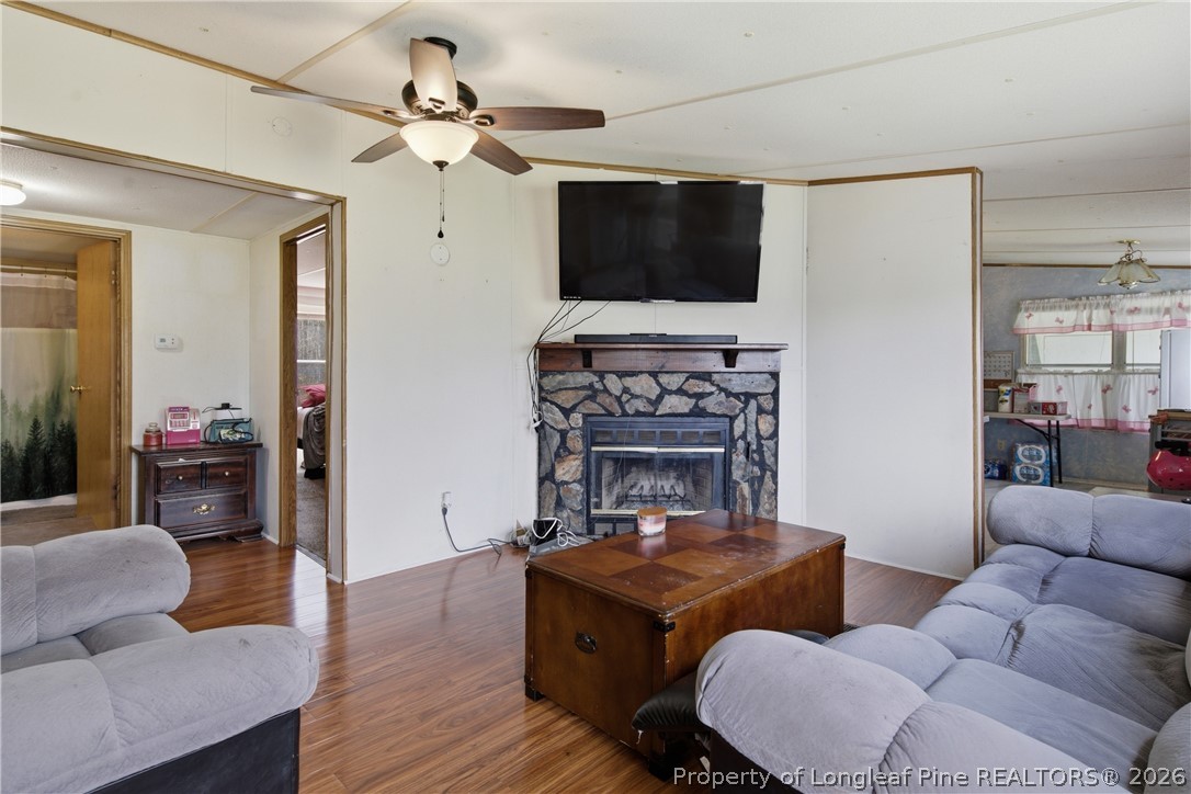 8637 Durant Nixon Road Linden, NC 28356 - Photo 17 of 36 a living room with furniture a flat screen tv and kitchen view