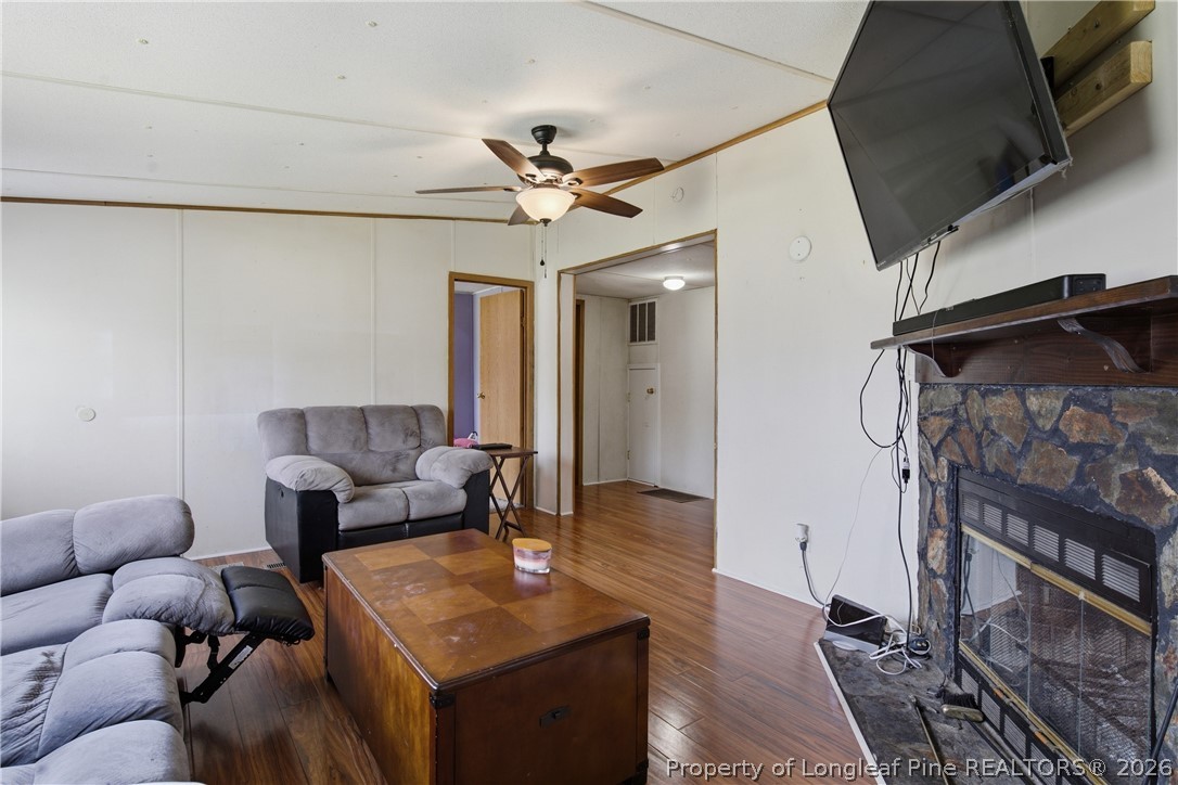8637 Durant Nixon Road Linden, NC 28356 - Photo 18 of 36 a living room with furniture a flat screen tv and a table
