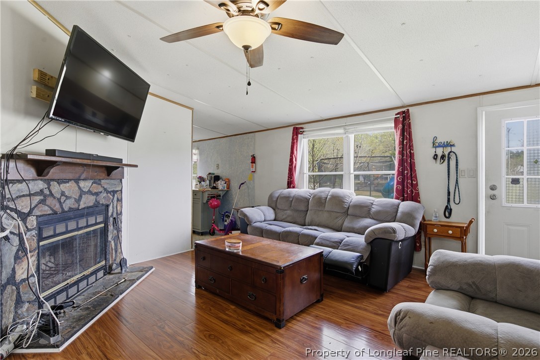 8637 Durant Nixon Road Linden, NC 28356 - Photo 19 of 36 a living room with furniture a flat screen tv and a fireplace