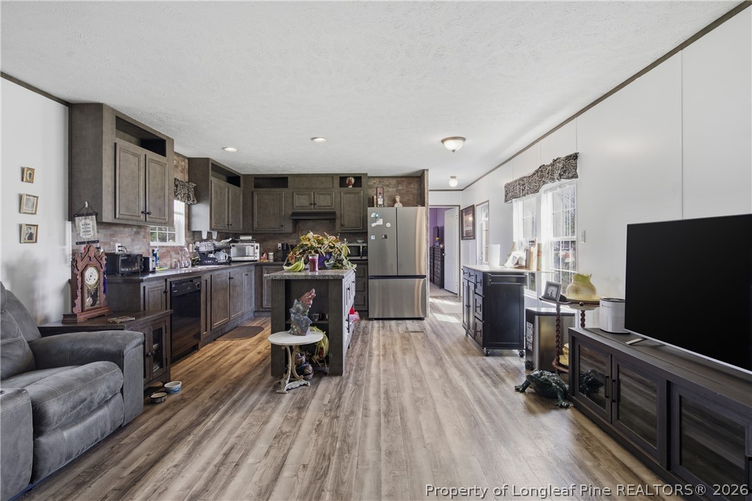 8637 Durant Nixon Road Linden, NC 28356 - Photo 2 of 36 a living room with furniture and a flat screen tv