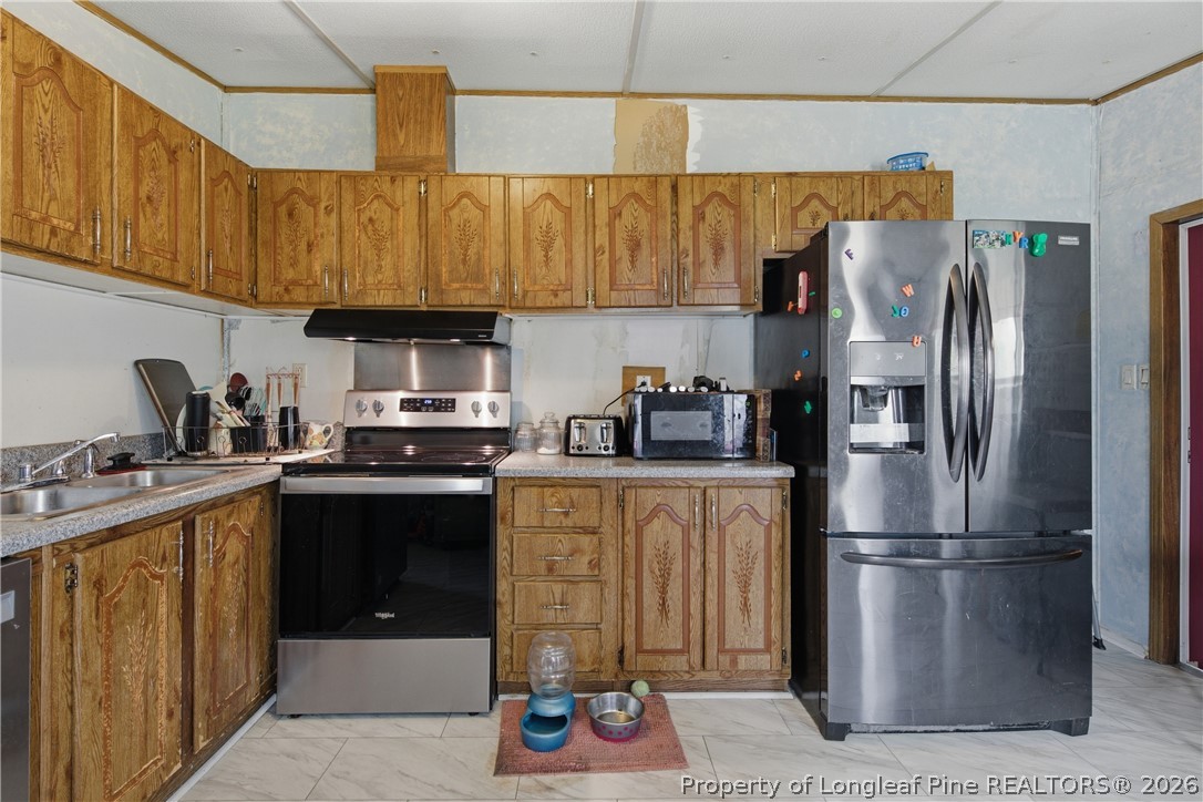 8637 Durant Nixon Road Linden, NC 28356 - Photo 22 of 36 a kitchen with stainless steel appliances granite countertop a refrigerator a stove and a sink