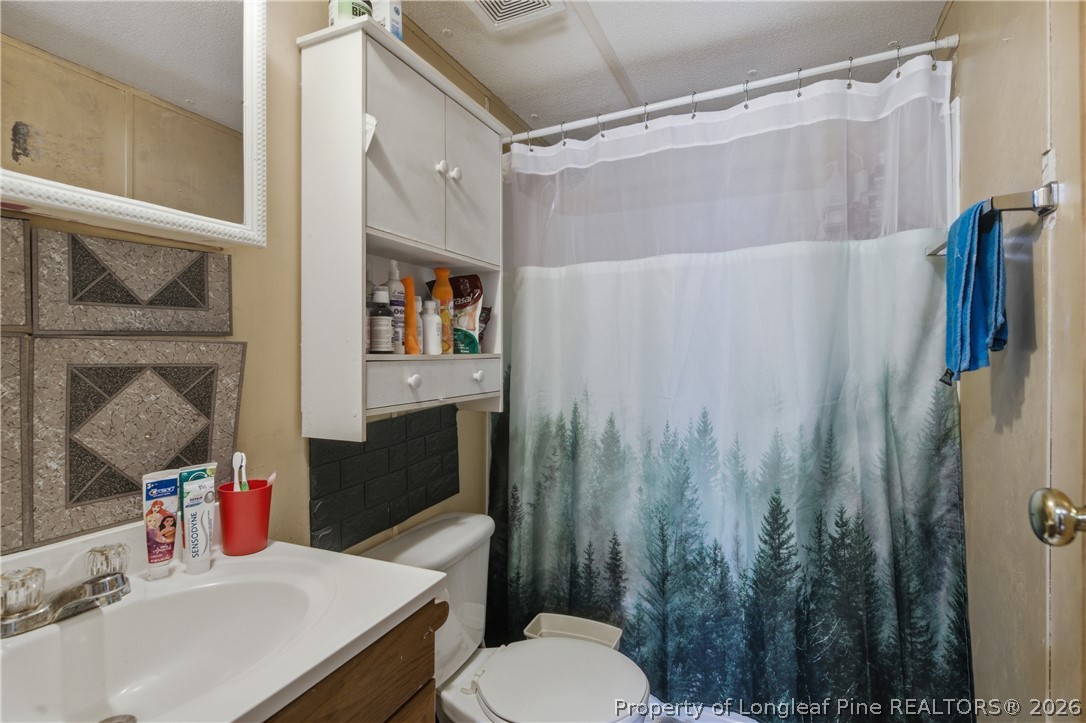 8637 Durant Nixon Road Linden, NC 28356 - Photo 26 of 36 a bathroom with a sink toilet and shower