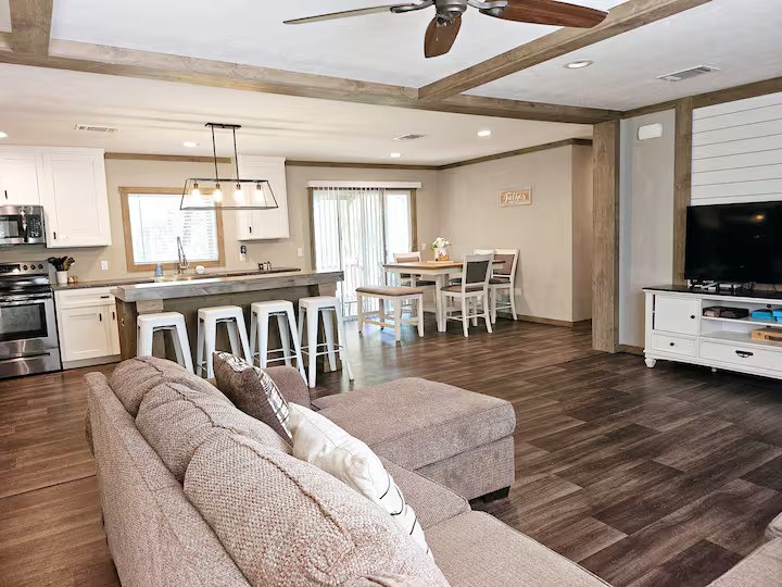 105 Saddle Surrey Road Coldspring, TX 77331 - Photo 11 of 48 a living room with furniture a flat screen tv and kitchen view