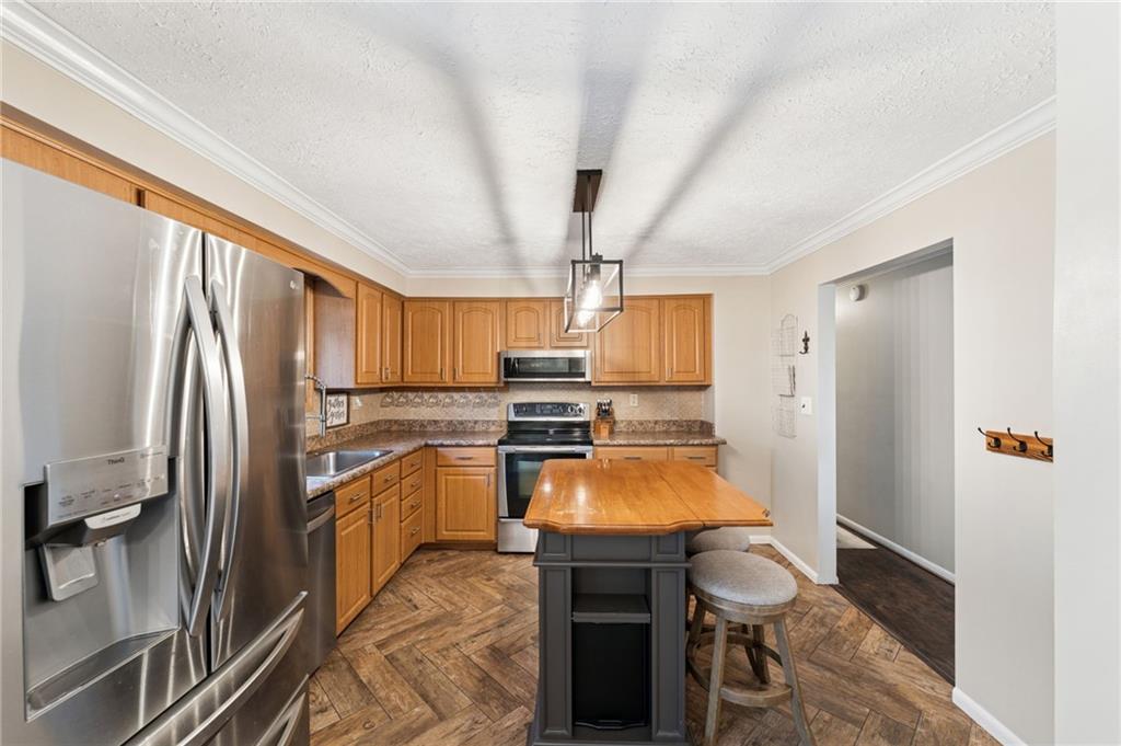 367 Brewer Road Rochester, PA 15074 - Photo 11 of 31 a kitchen with granite countertop a refrigerator stove and sink