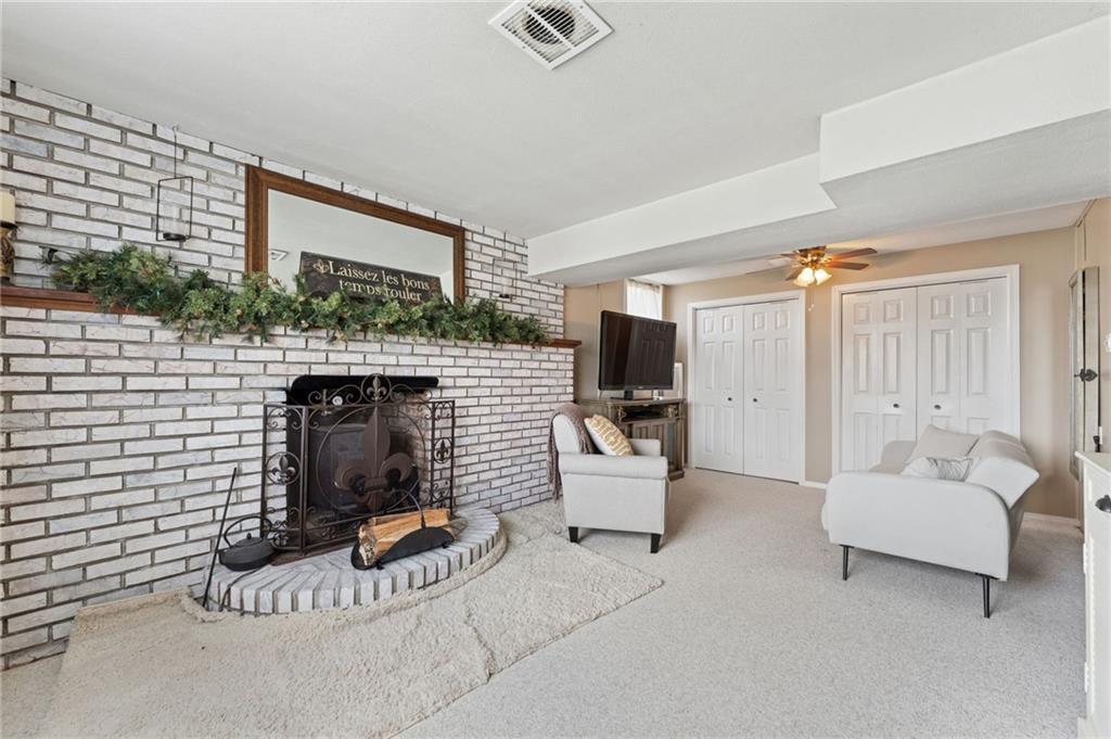367 Brewer Road Rochester, PA 15074 - Photo 23 of 31 a living room with furniture a flat screen tv and a fireplace