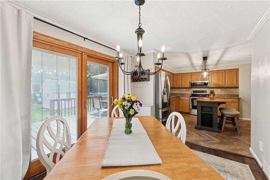 367 Brewer Road Rochester, PA 15074 - Photo 10 of 31 a dining room with stainless steel appliances granite countertop a stove a refrigerator a oven with a dining table and chairs