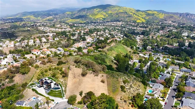 an aerial view of a house with a yard and fountain