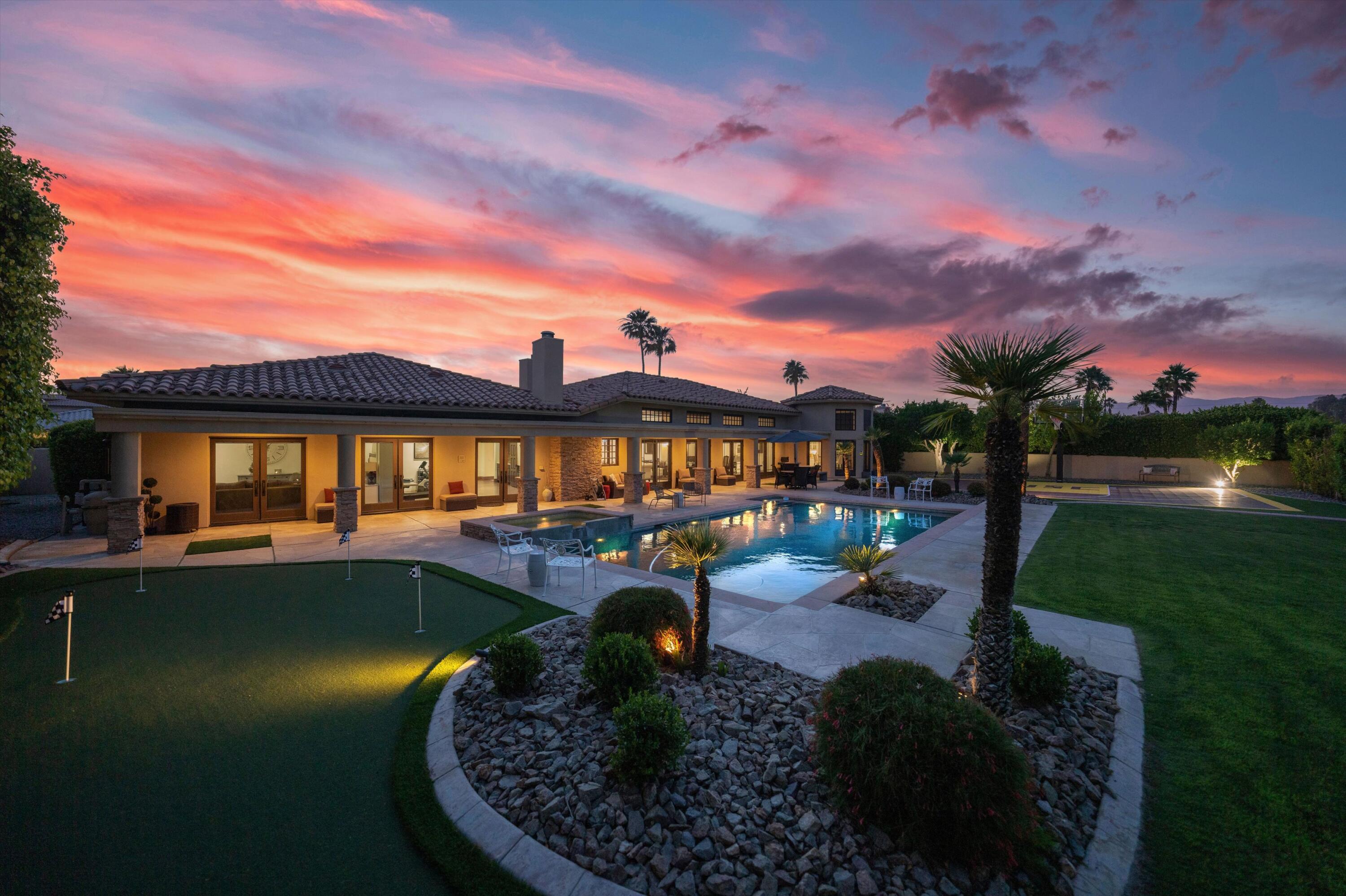 a view of a swimming pool with a table and chairs