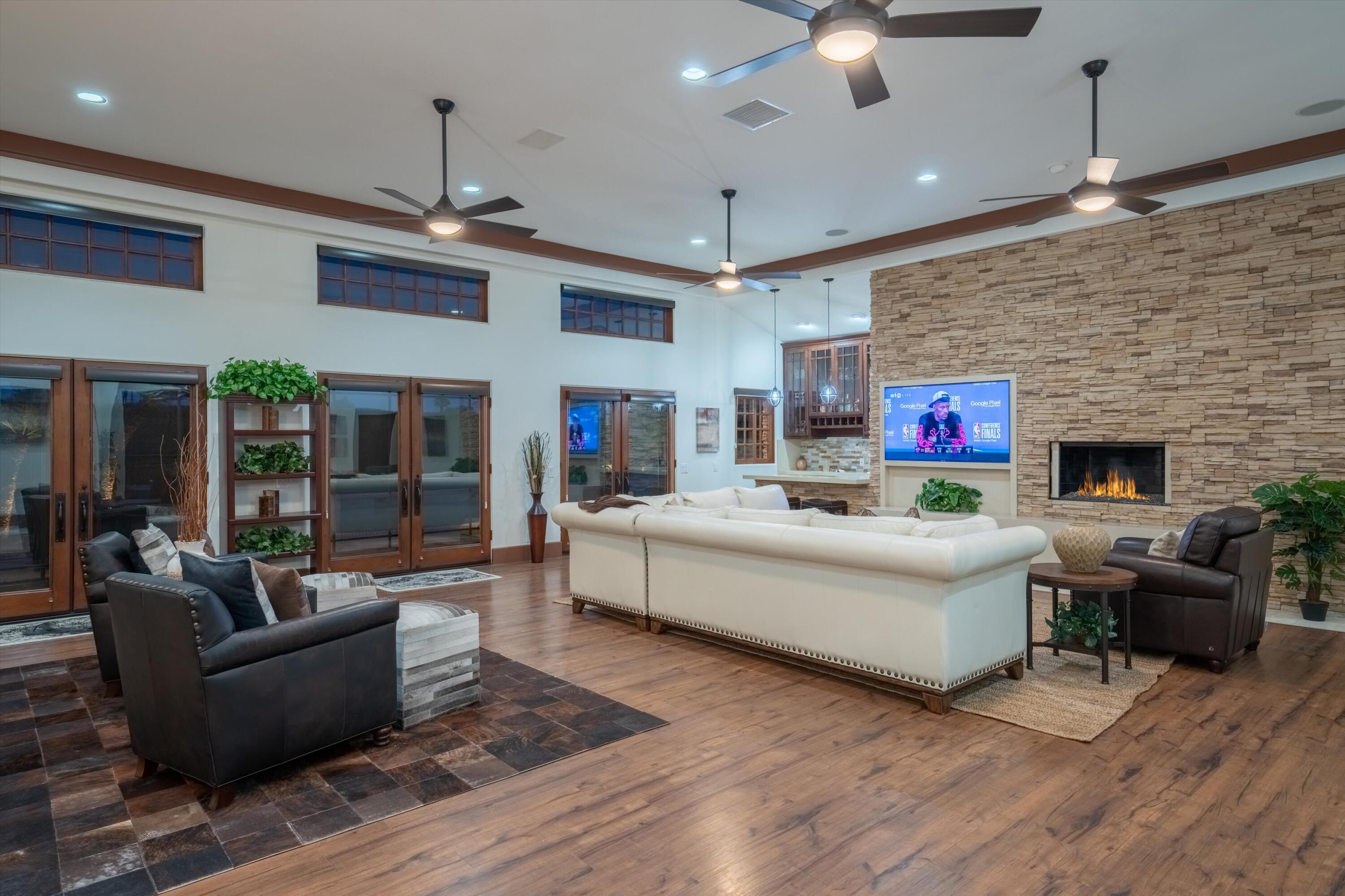 43190 Moore Circle Bermuda Dunes, CA 92203 - Photo 12 of 50 a living room with furniture a fireplace and a ceiling fan
