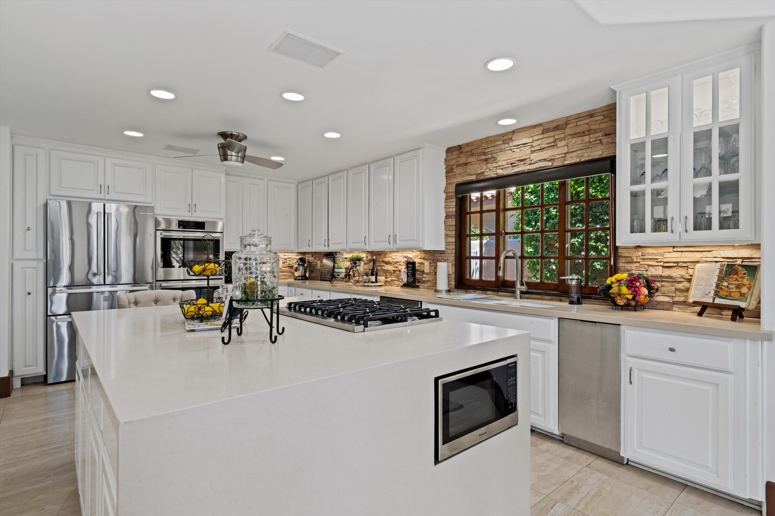 43190 Moore Circle Bermuda Dunes, CA 92203 - Photo 14 of 50 a view of kitchen with sink microwave refrigerator and cabinets