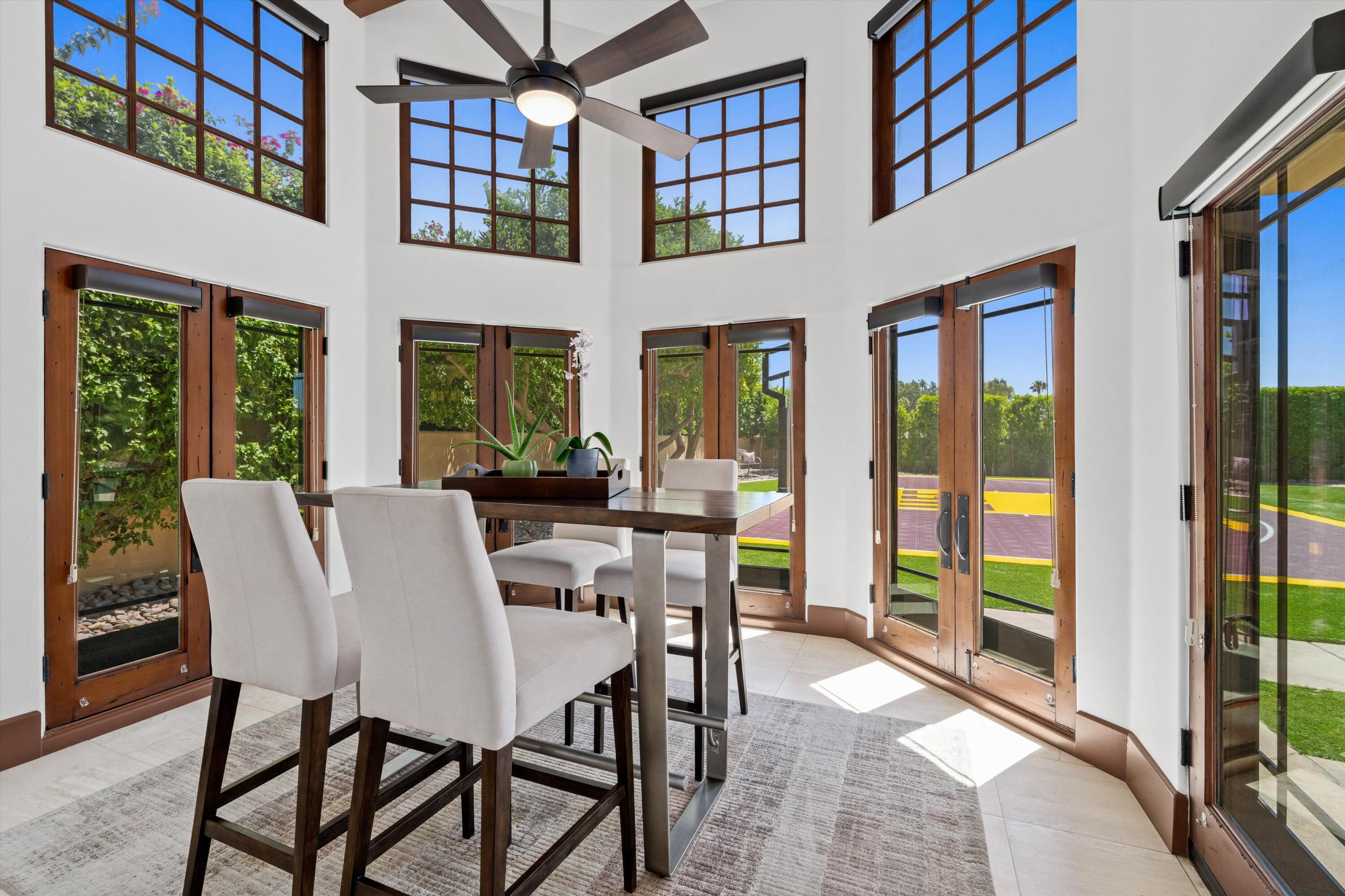 43190 Moore Circle Bermuda Dunes, CA 92203 - Photo 17 of 50 a view of a dining room with furniture large windows and wooden floor