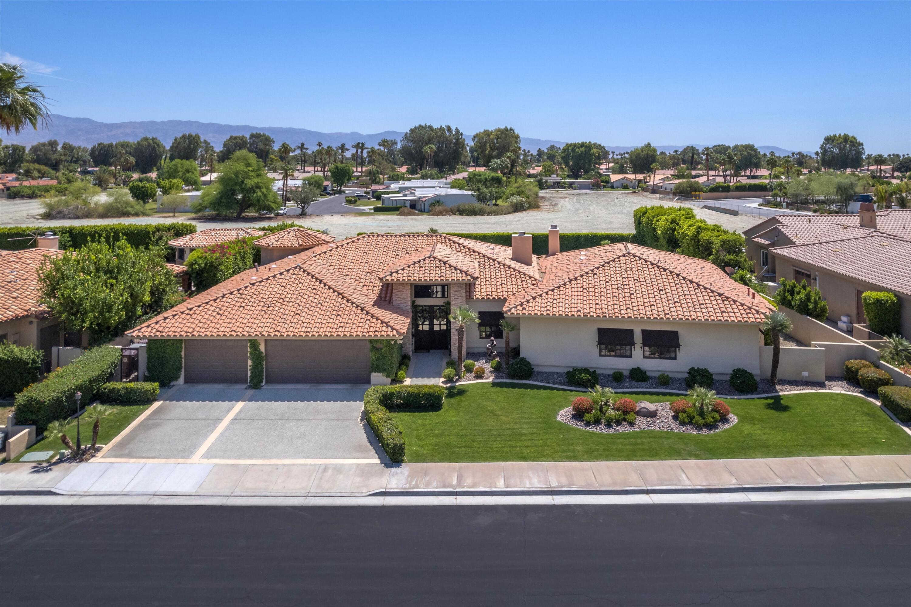 43190 Moore Circle Bermuda Dunes, CA 92203 - Photo 2 of 50 an aerial view of a house with a garden and lake view
