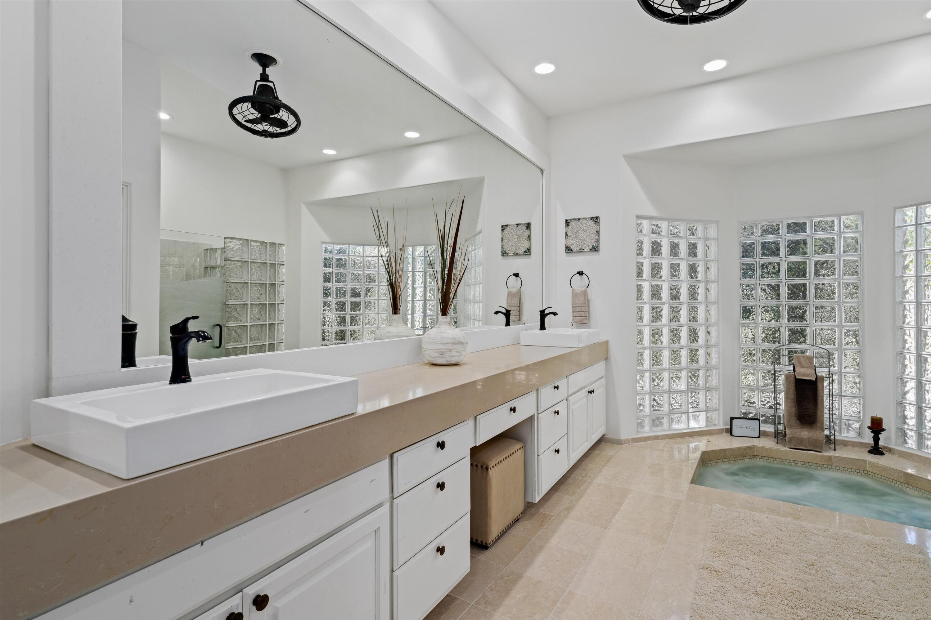 43190 Moore Circle Bermuda Dunes, CA 92203 - Photo 28 of 50 a spacious bathroom with double vanity and a shower