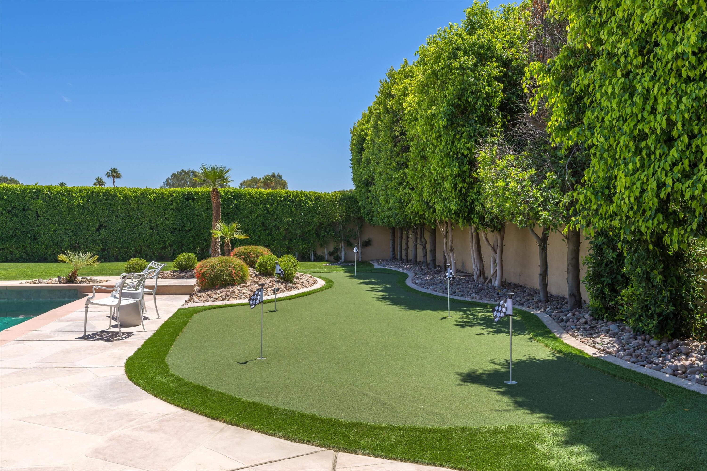 43190 Moore Circle Bermuda Dunes, CA 92203 - Photo 41 of 50 a view of a swimming pool with lawn chairs and a big yard