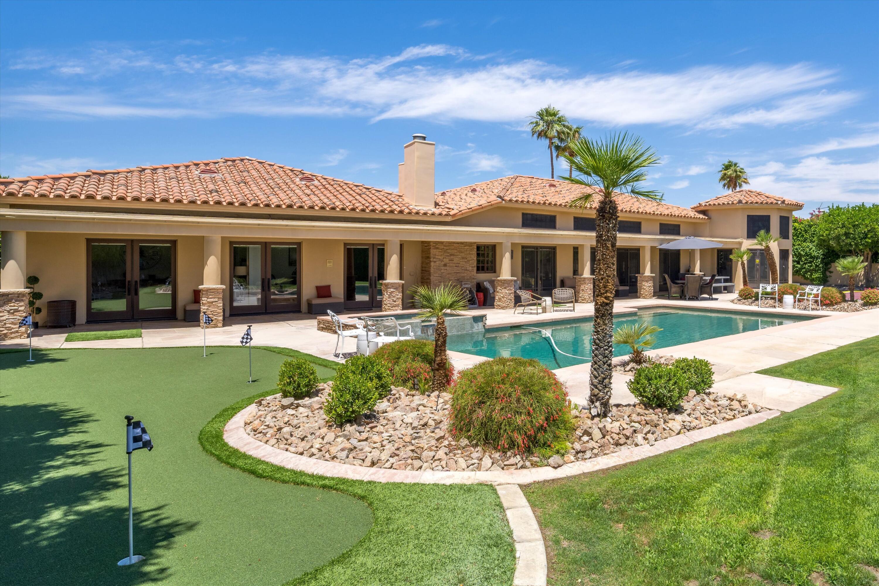 43190 Moore Circle Bermuda Dunes, CA 92203 - Photo 45 of 50 a view of a house with a swimming pool and a yard