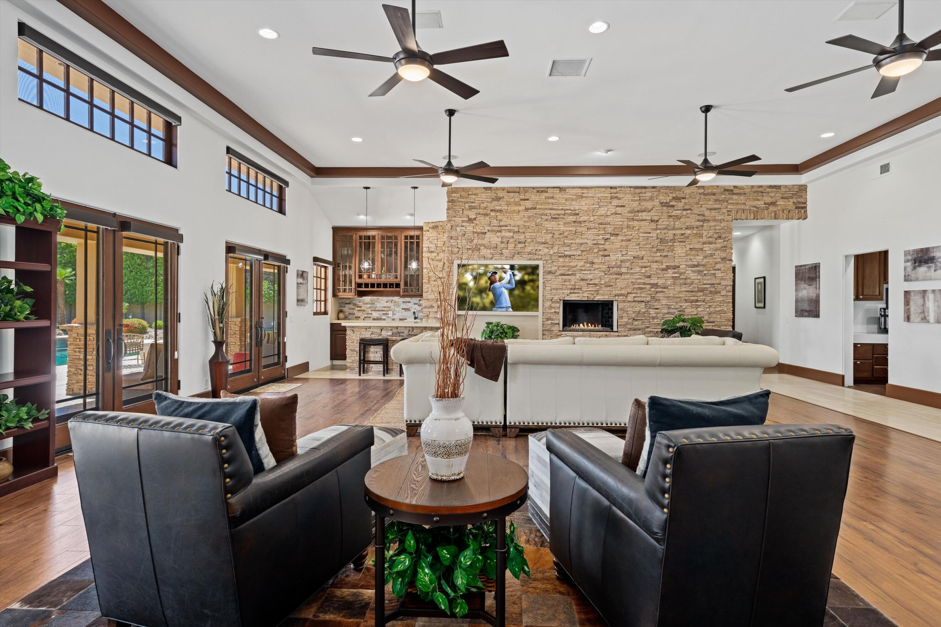 43190 Moore Circle Bermuda Dunes, CA 92203 - Photo 10 of 50 a living room with furniture a fireplace and a chandelier