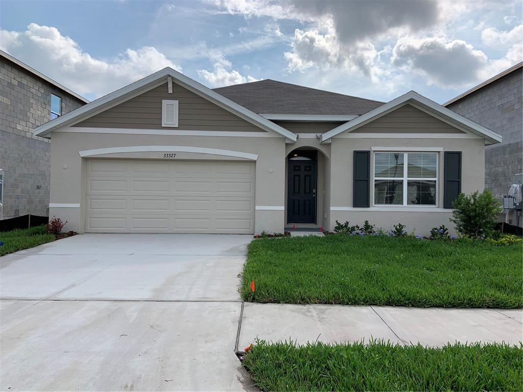 33327 Hamilton Hl Lane Wesley Chapel, FL 33545 - Photo 1 of 11 a front view of a house with a yard and garage