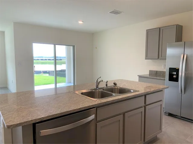 a kitchen with a sink a counter space and stainless steel appliances