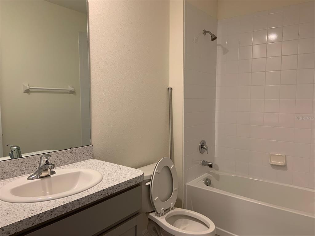 33327 Hamilton Hl Lane Wesley Chapel, FL 33545 - Photo 9 of 11 a bathroom with a granite countertop sink toilet and shower