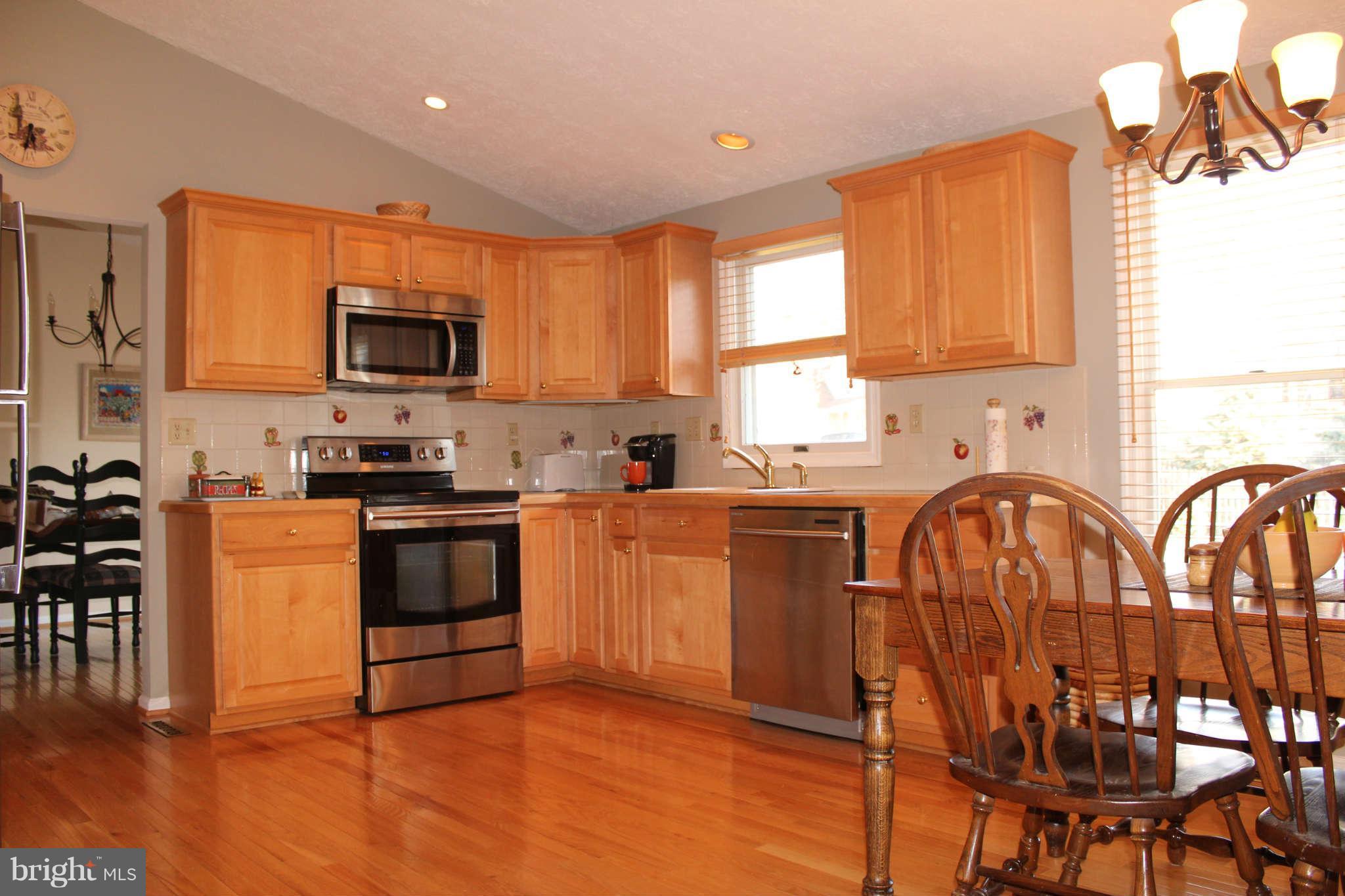 3065 Memory Lane Silver Spring, MD 20904 - Photo 7 of 29 a kitchen with granite countertop a stove top oven a sink a window and stainless steel appliances