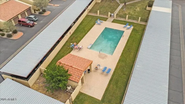 a view of a house with backyard and trees