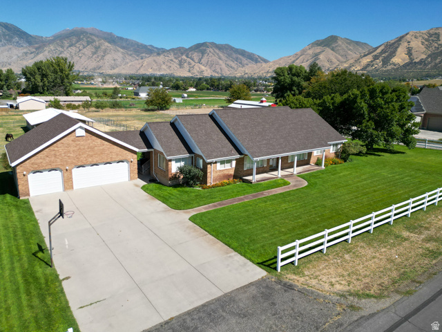 1060 West 2620th Street South Mapleton, UT 84664 - Photo 1 of 87 Ranch-style home featuring a porch, brick siding, a mountain view, and driveway
