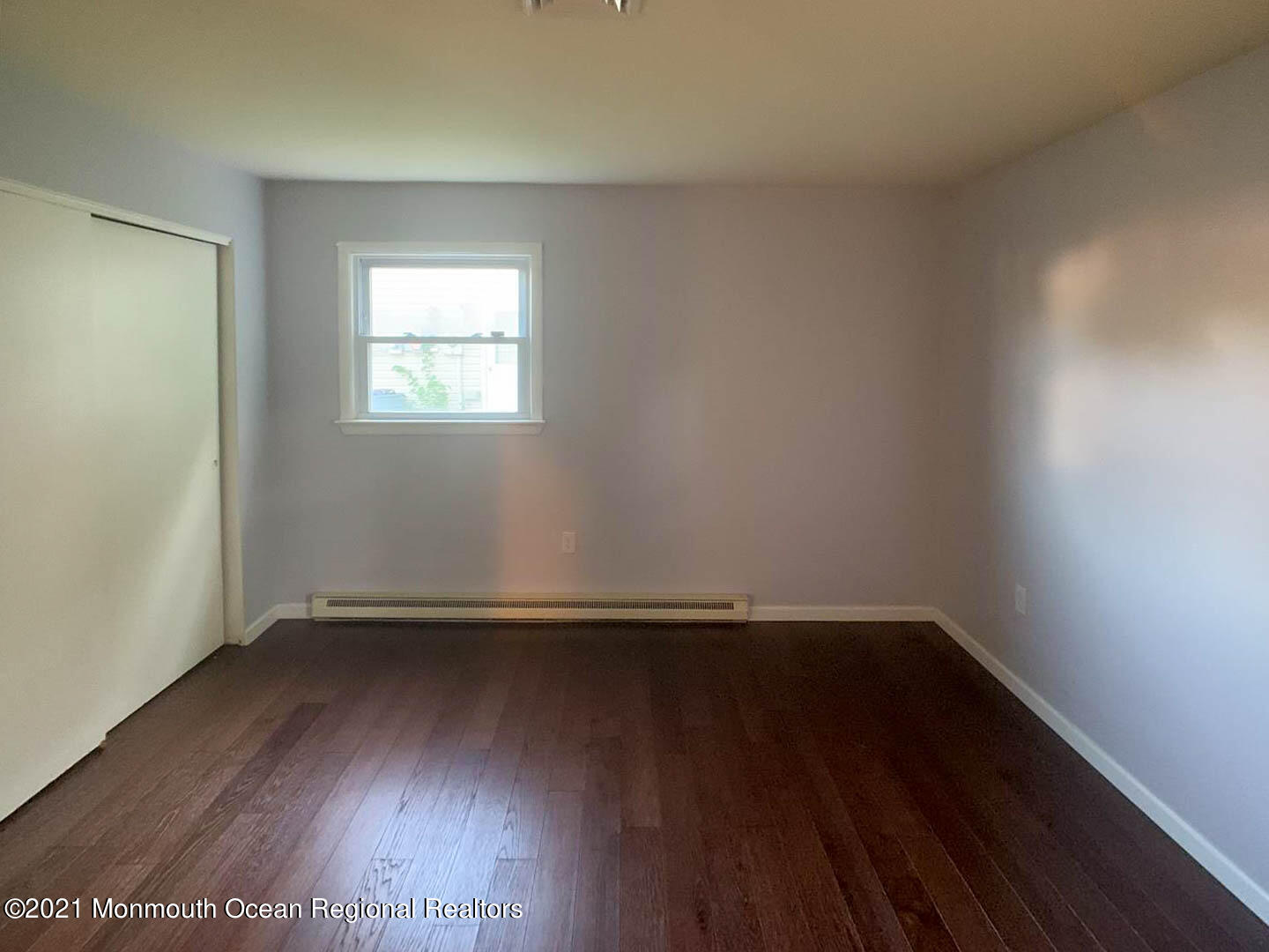 109 Beverly Drive Barnegat, NJ 08005 - Photo 15 of 20 an empty room with wooden floor and window