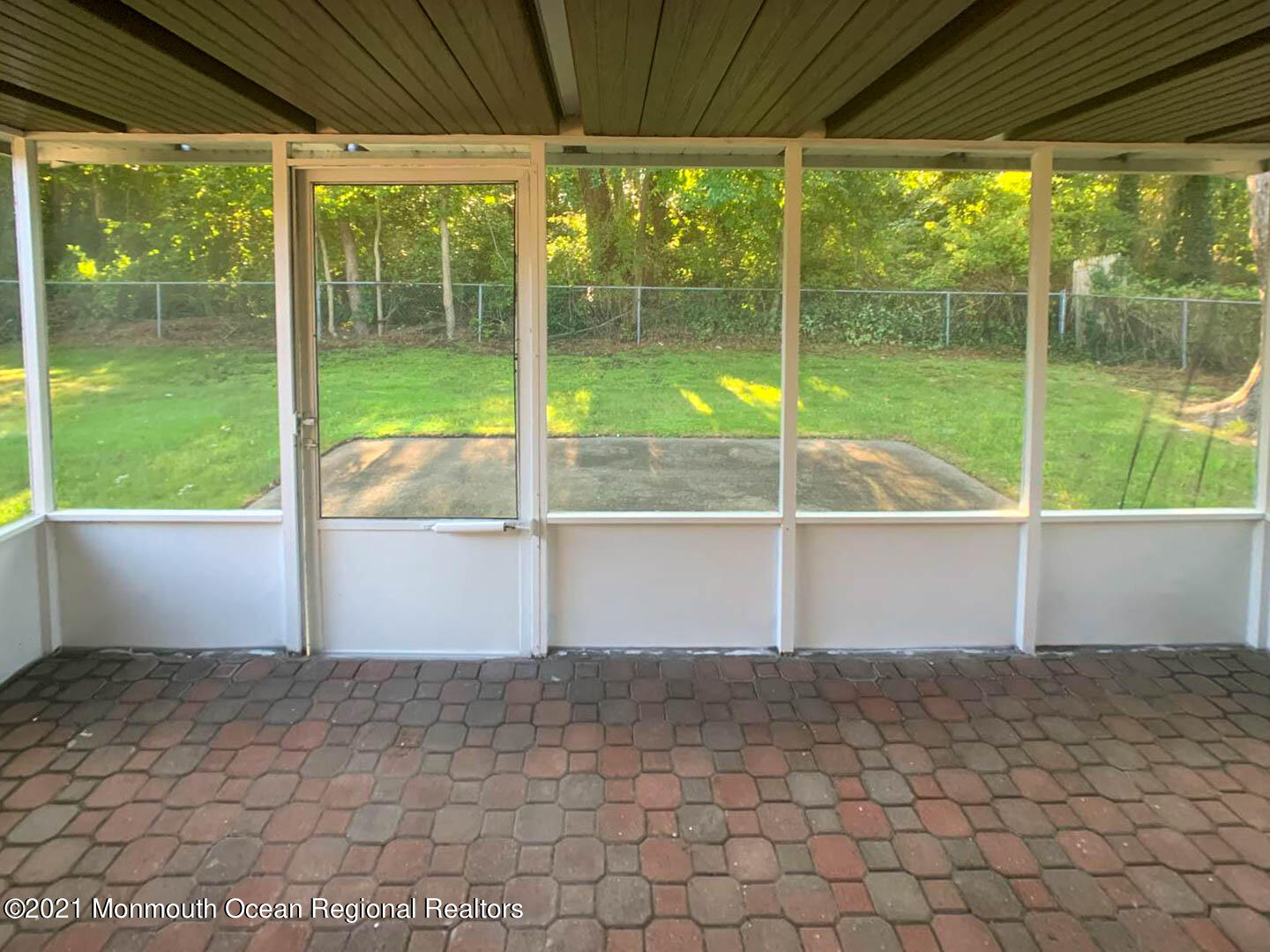 109 Beverly Drive Barnegat, NJ 08005 - Photo 5 of 20 a view of a porch with table and chairs under an umbrella