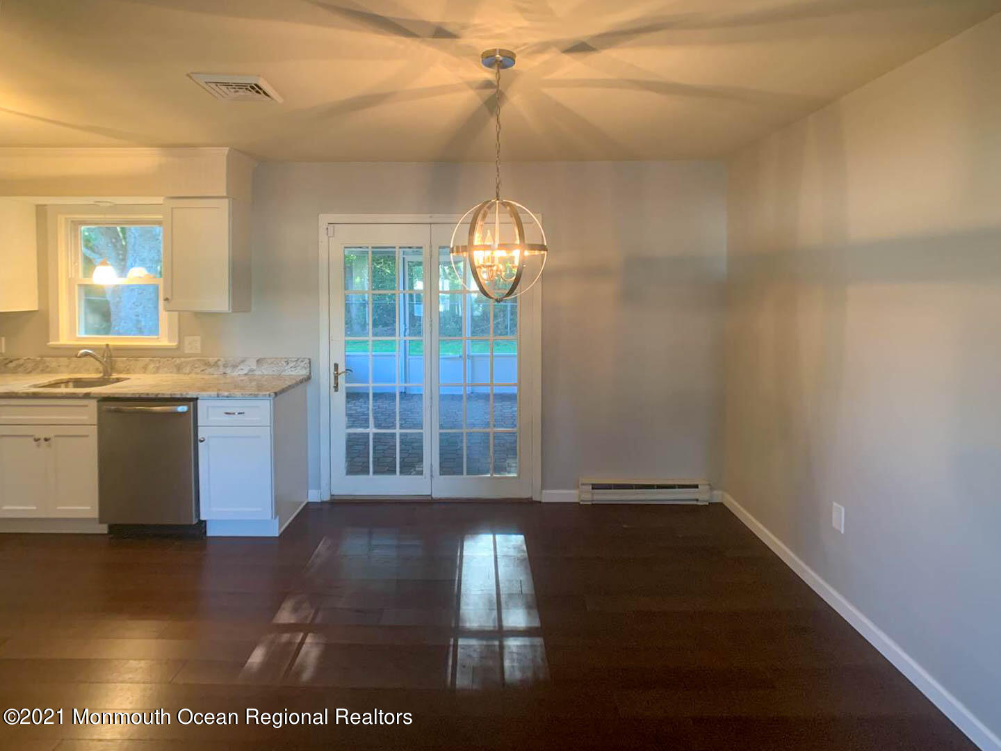 109 Beverly Drive Barnegat, NJ 08005 - Photo 7 of 20 a view of a hallway with wooden floor and a kitchen