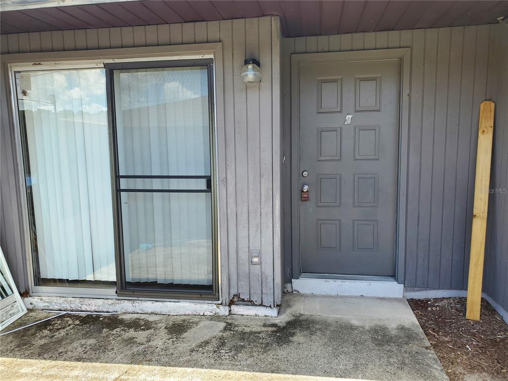 5375 Southeast 29th Place, Unit B Ocala, FL 34480 - Photo 3 of 11 a view of a wooden door and a window