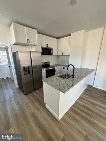 a kitchen with stainless steel appliances a microwave a sink a stove and refrigerator