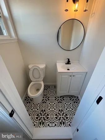 a bathroom with a toilet sink and mirror