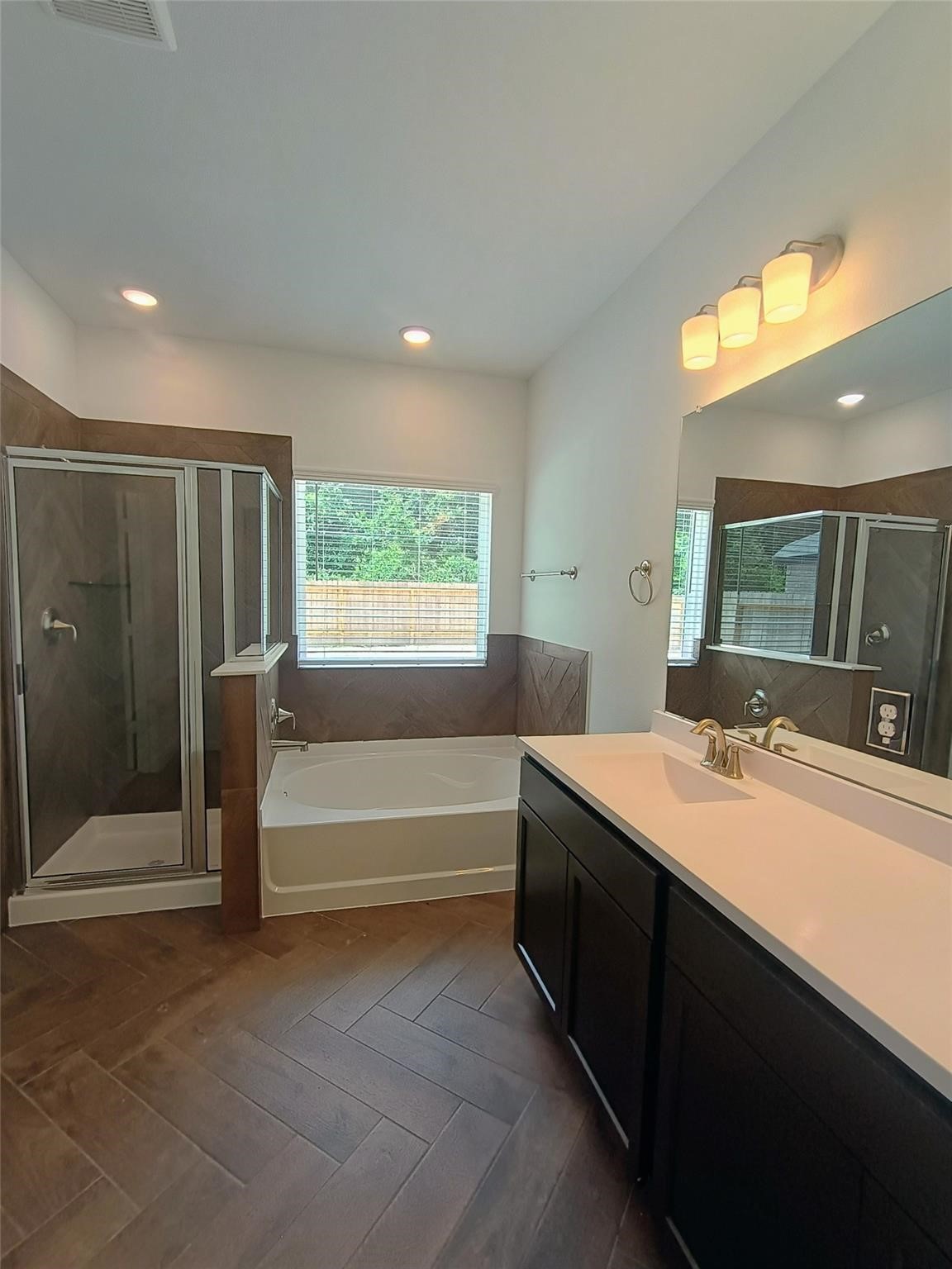 15924 Cy Young Court Splendora, TX 77372 - Photo 14 of 29 a bathroom with a tub sink and mirror