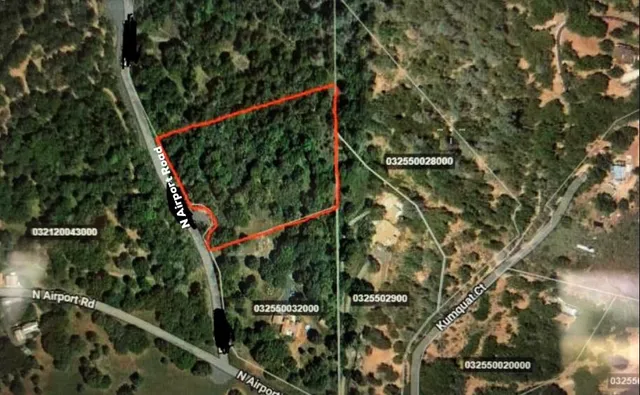 a view of a field with an trees in the background