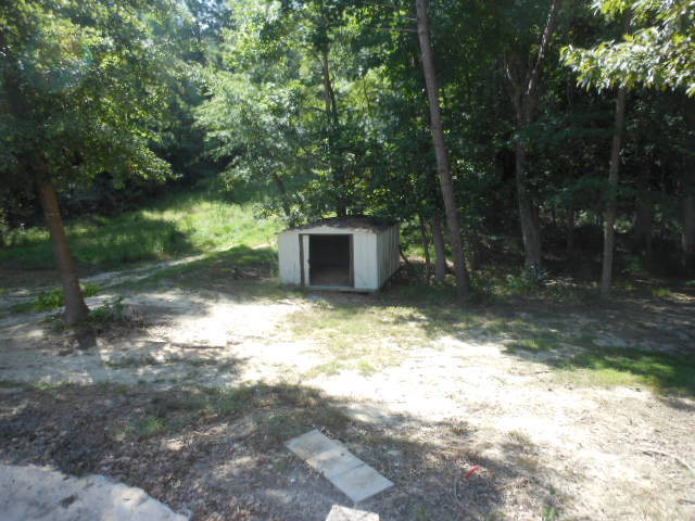152 Morris Stevens Road Macon, GA 31217 - Photo 11 of 11 a backyard of a house with lots of green space