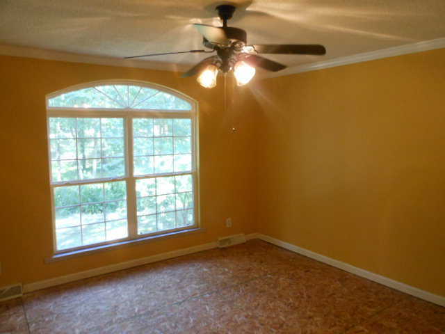 152 Morris Stevens Road Macon, GA 31217 - Photo 6 of 11 an empty room with a window and chandelier fan
