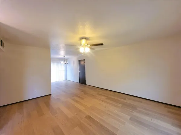 a view of a livingroom and a chandelier fan