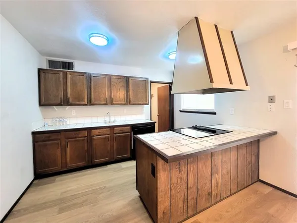 a kitchen with a stove a sink and a refrigerator