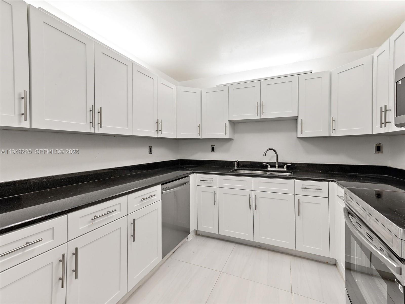 13841 Southwest 17th Terrace Miami, FL 33175 - Photo 18 of 31 a kitchen with granite countertop white cabinets and white appliances