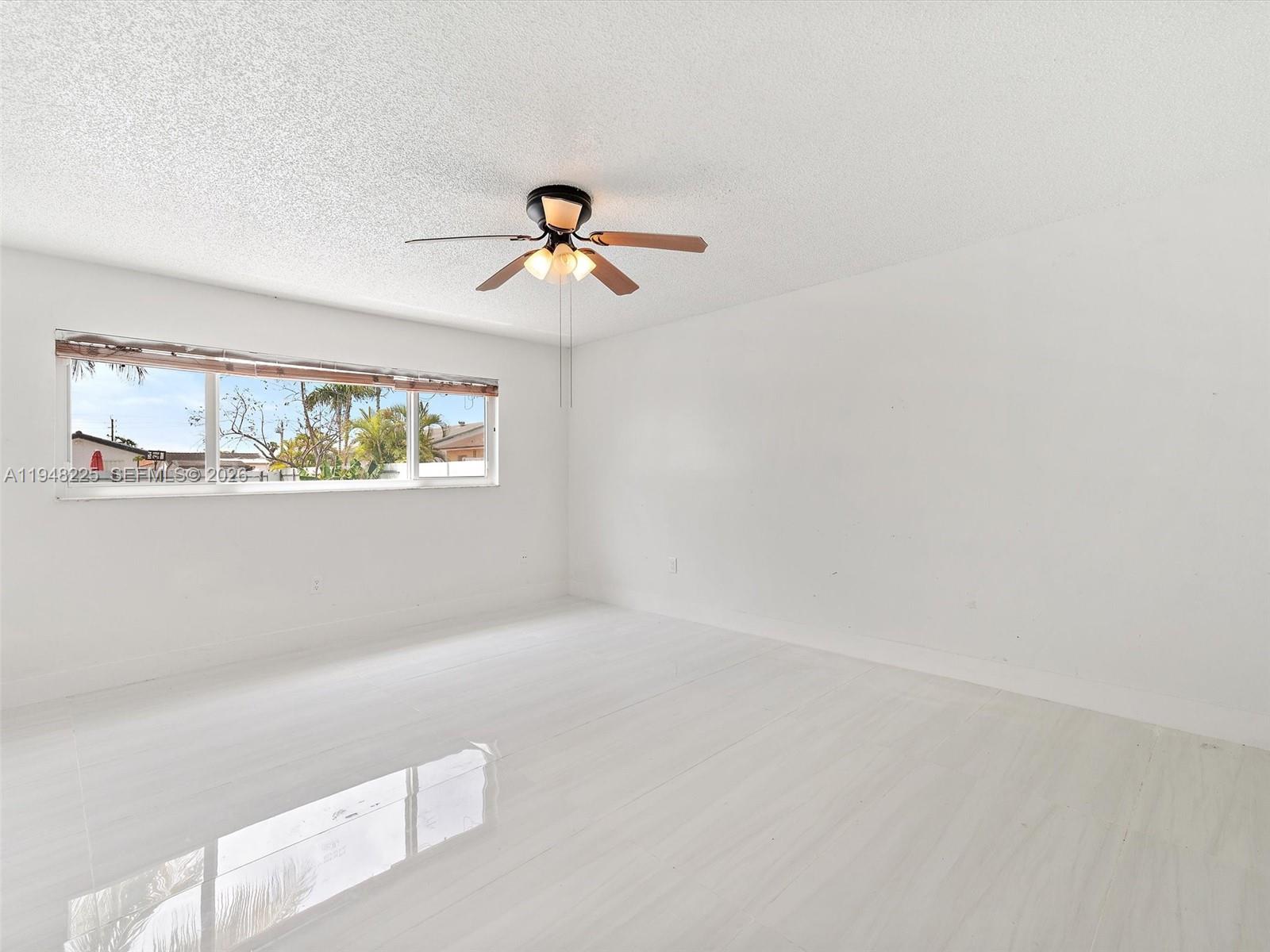 13841 Southwest 17th Terrace Miami, FL 33175 - Photo 19 of 31 a view of room with a ceiling fan and window
