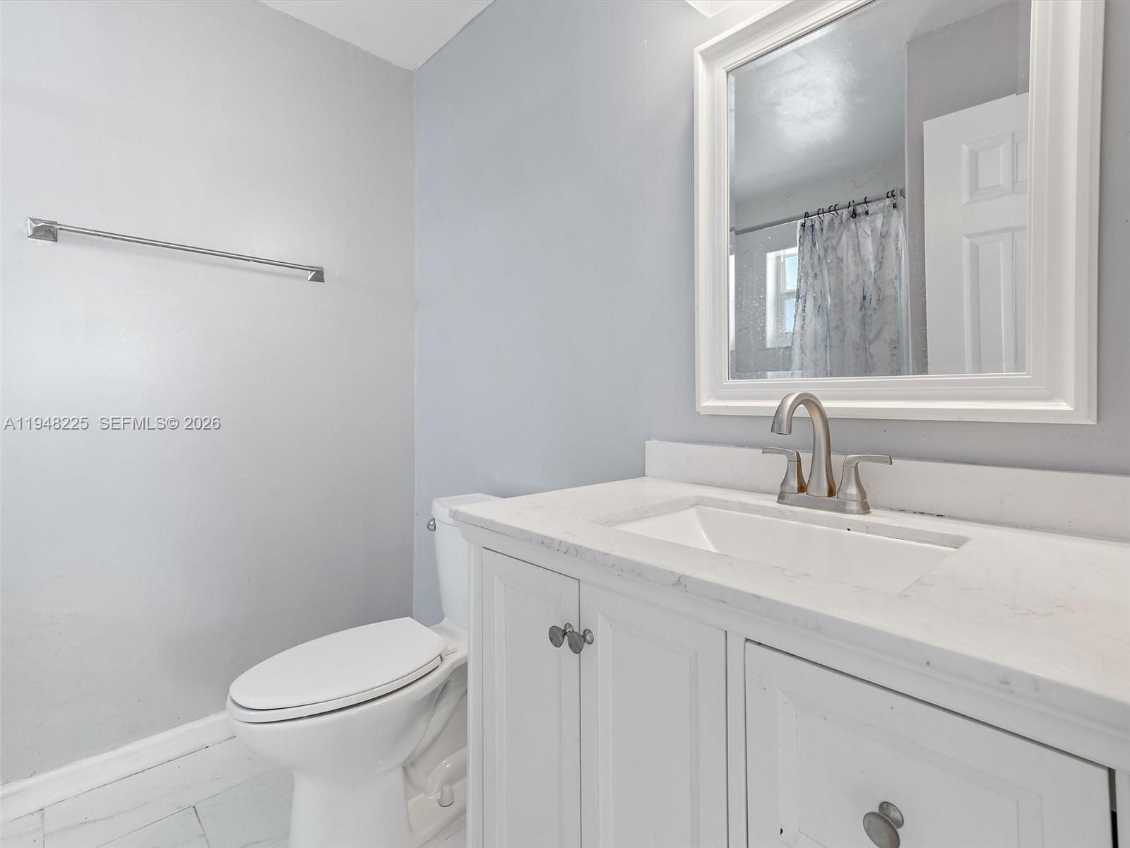 13841 Southwest 17th Terrace Miami, FL 33175 - Photo 21 of 31 a bathroom with a sink a toilet and a mirror