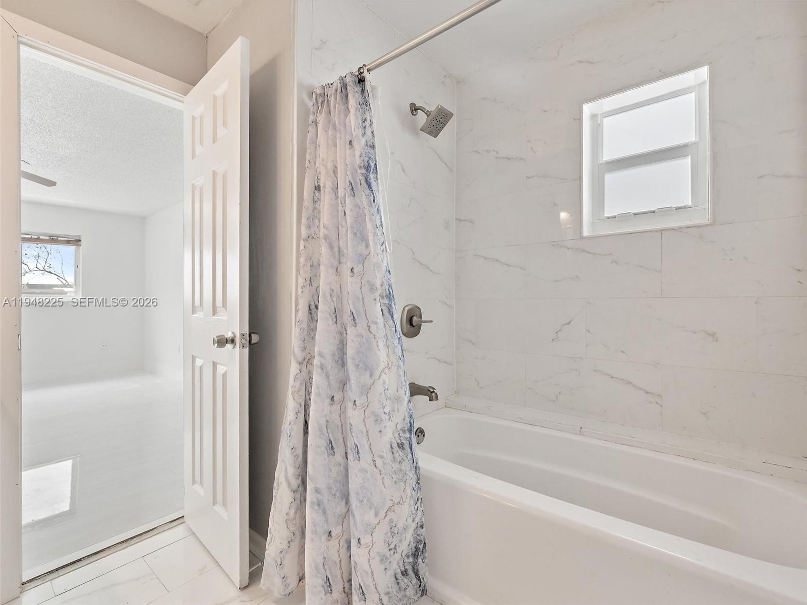 13841 Southwest 17th Terrace Miami, FL 33175 - Photo 22 of 31 a bathroom with a bathtub and a shower