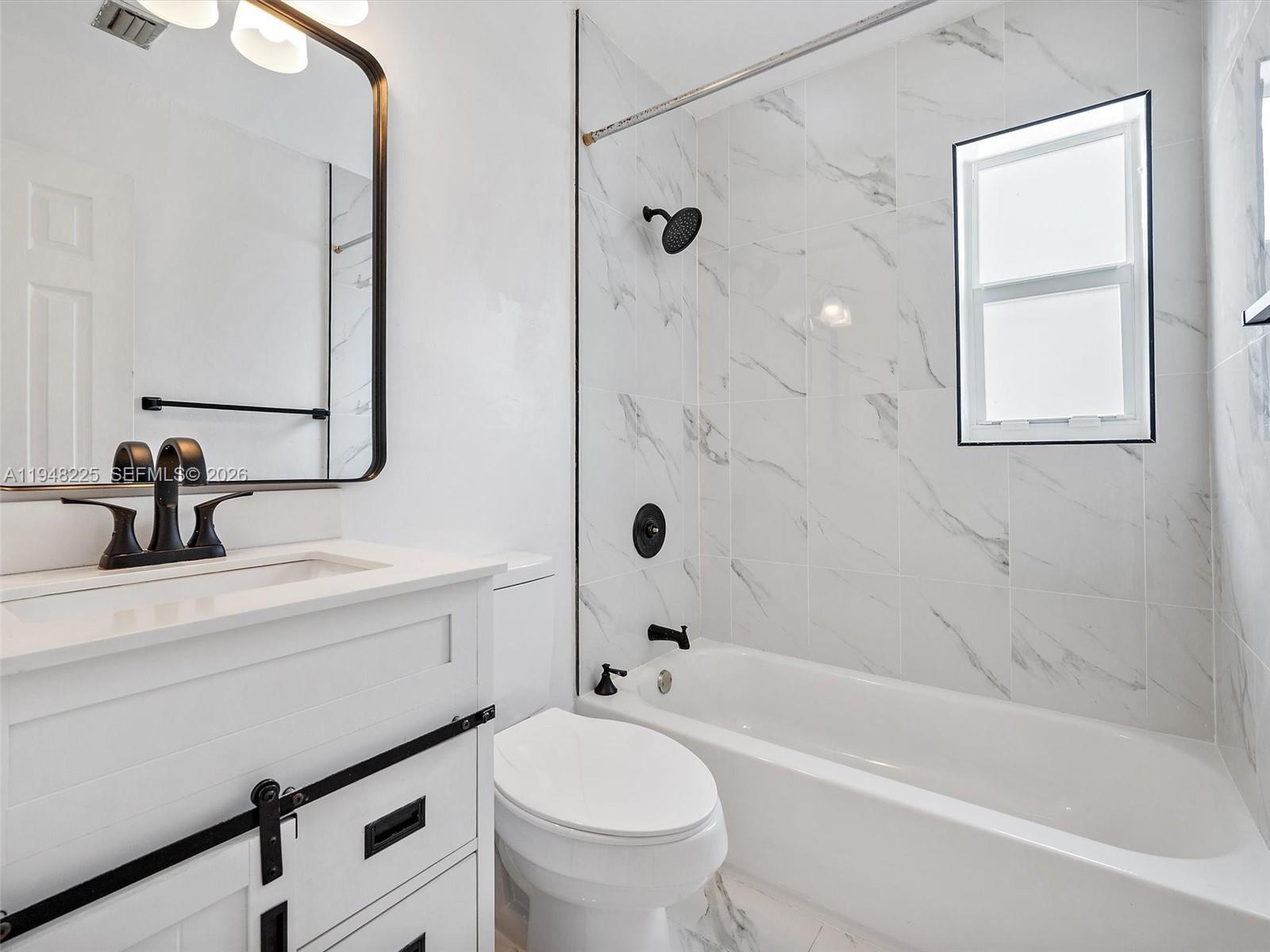 13841 Southwest 17th Terrace Miami, FL 33175 - Photo 25 of 31 a bathroom with a sink a toilet and a bathtub