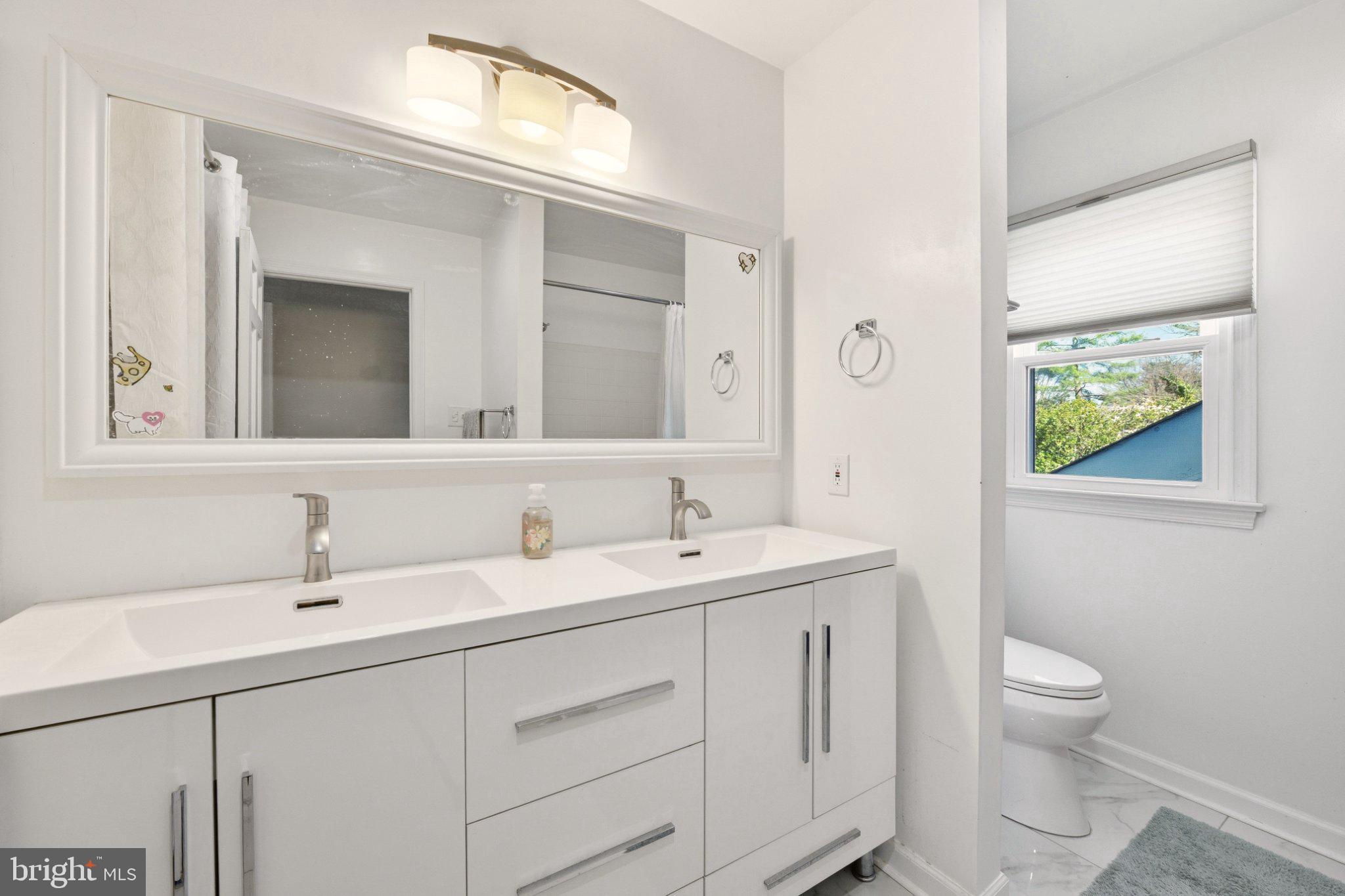 2311 Spencer Road Silver Spring, MD 20910 - Photo 19 of 36 Sleek modern bathroom with natural light.
