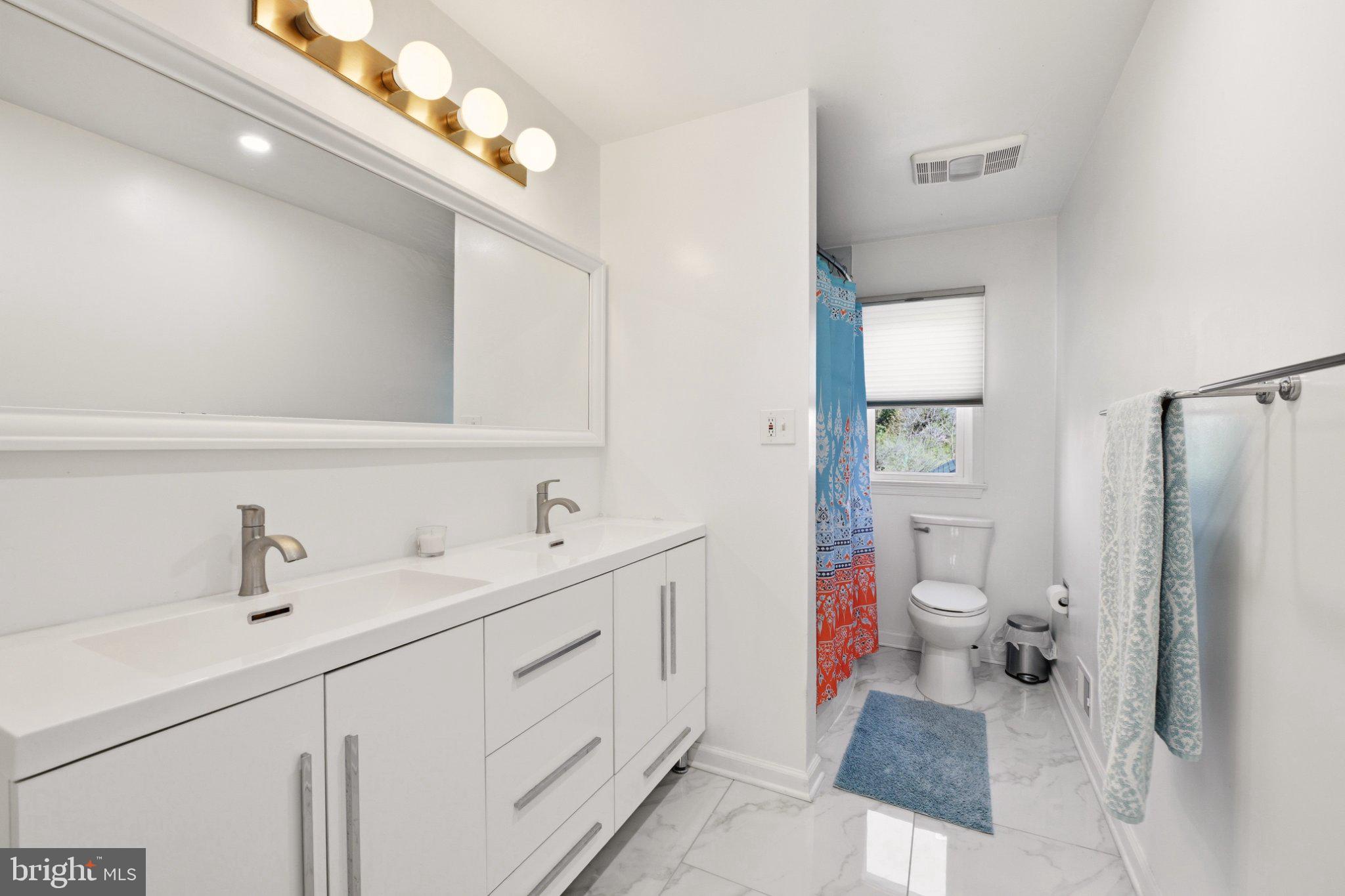 2311 Spencer Road Silver Spring, MD 20910 - Photo 30 of 36 Sleek modern bathroom with bright accents.