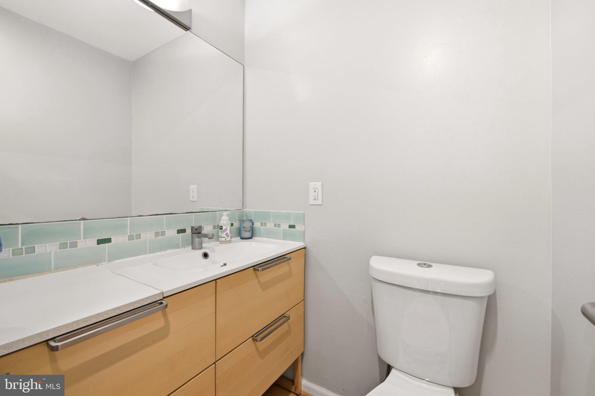 2311 Spencer Road Silver Spring, MD 20910 - Photo 6 of 36 Sleek modern bathroom with serene tones.