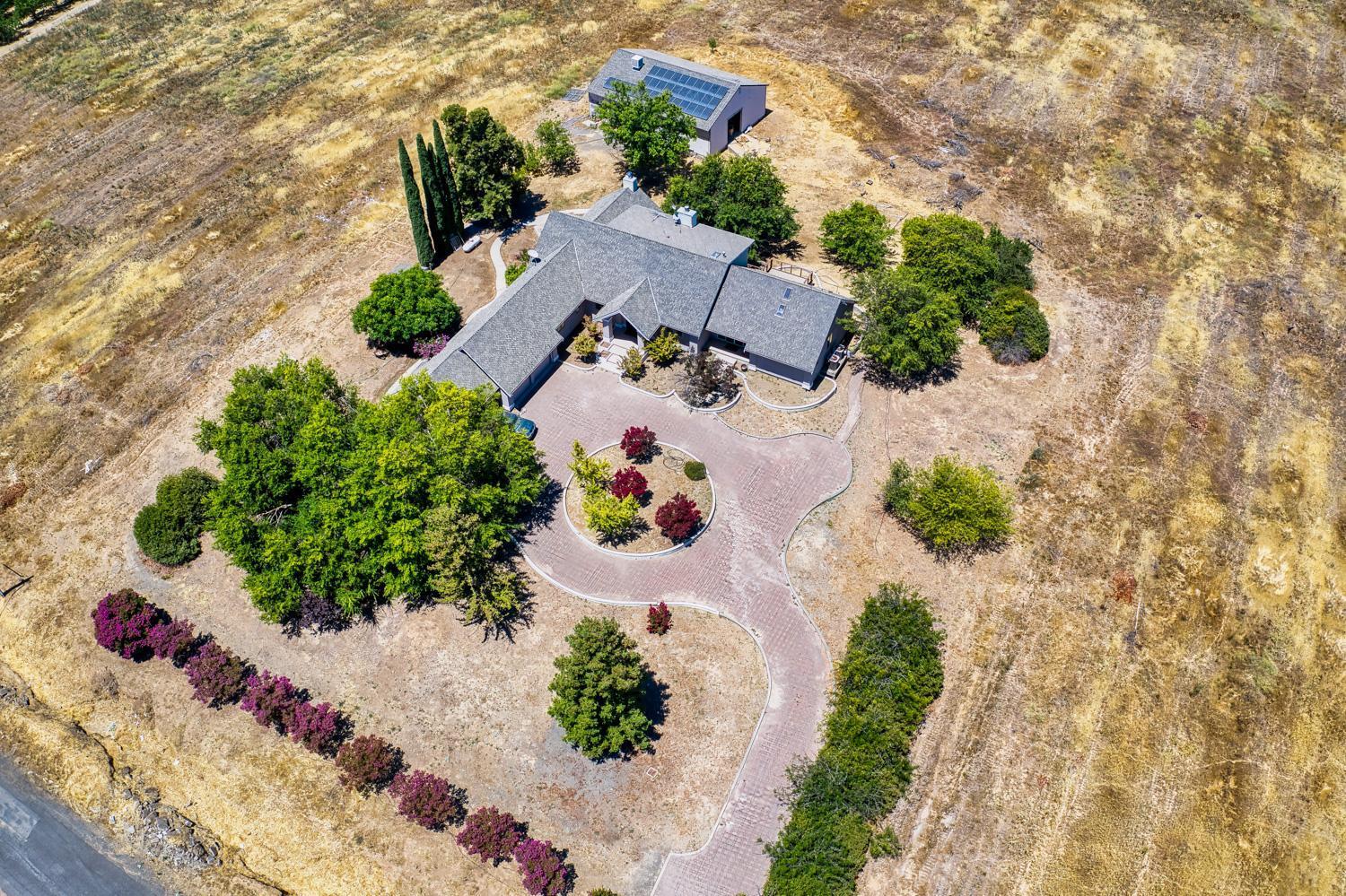 an aerial view of a house with a yard