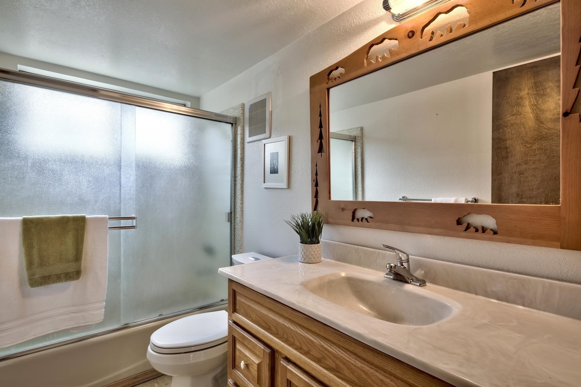 15541 Glenshire Drive Truckee, CA 96161 - Photo 13 of 21 a bathroom with a granite countertop sink toilet a mirror and shower