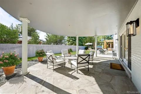 a view of a patio with table and chairs potted plants with wooden floor