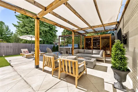 a view of a patio with a dining table and chairs